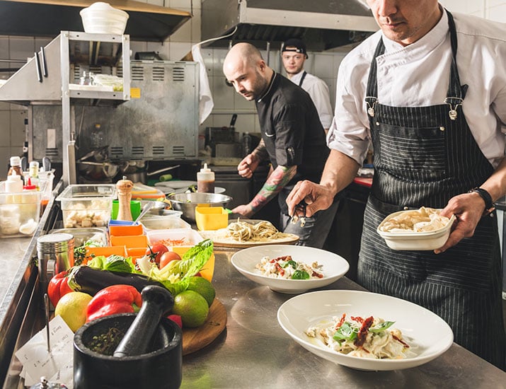 Chefs in the kitchen serving food